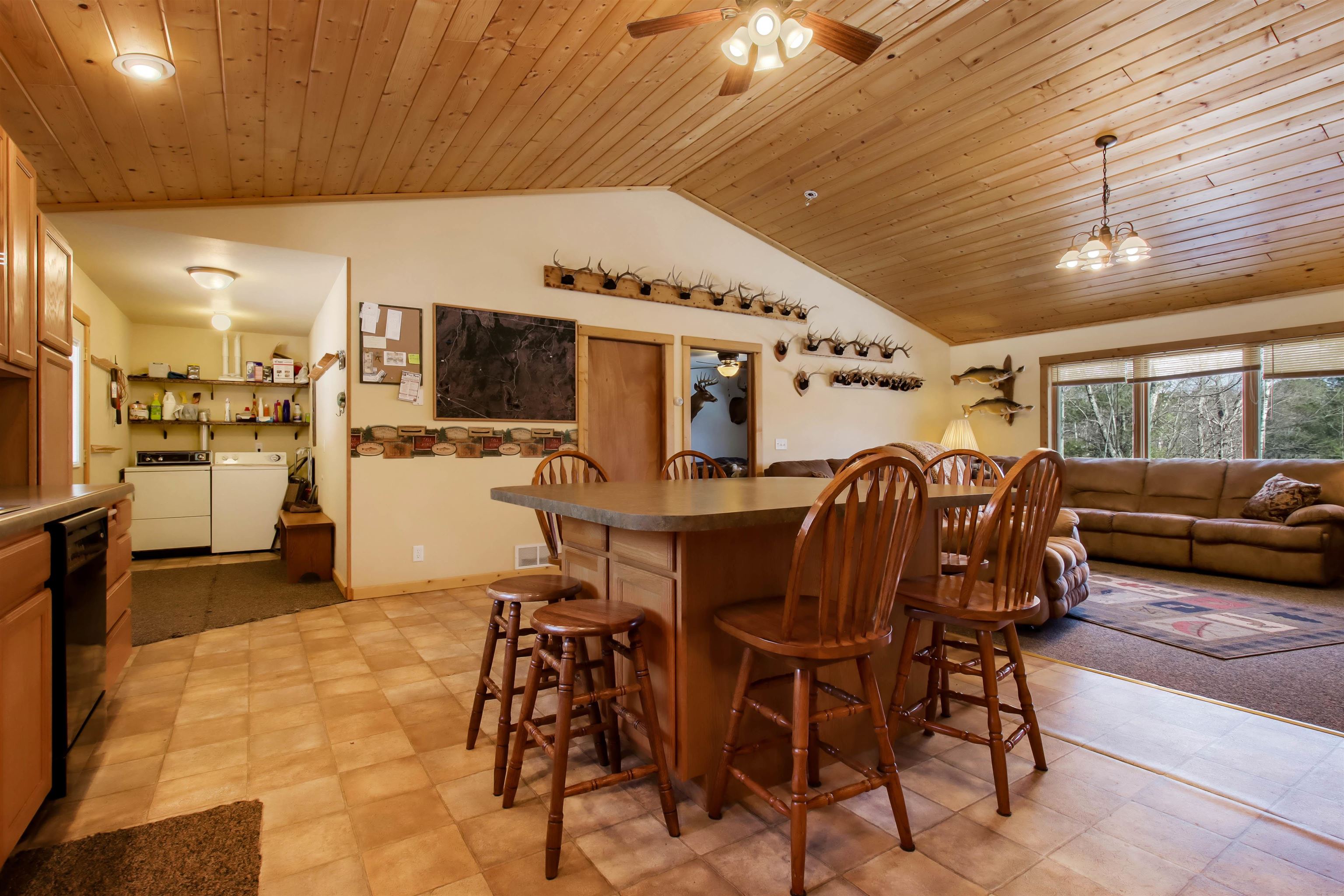 16525 Sand Hill Road Mason, WI 54856 - Photo 7 of 38 Dining space with washer and clothes dryer, vaulted ceiling, wood ceiling, a ceiling fan, and a dry bar