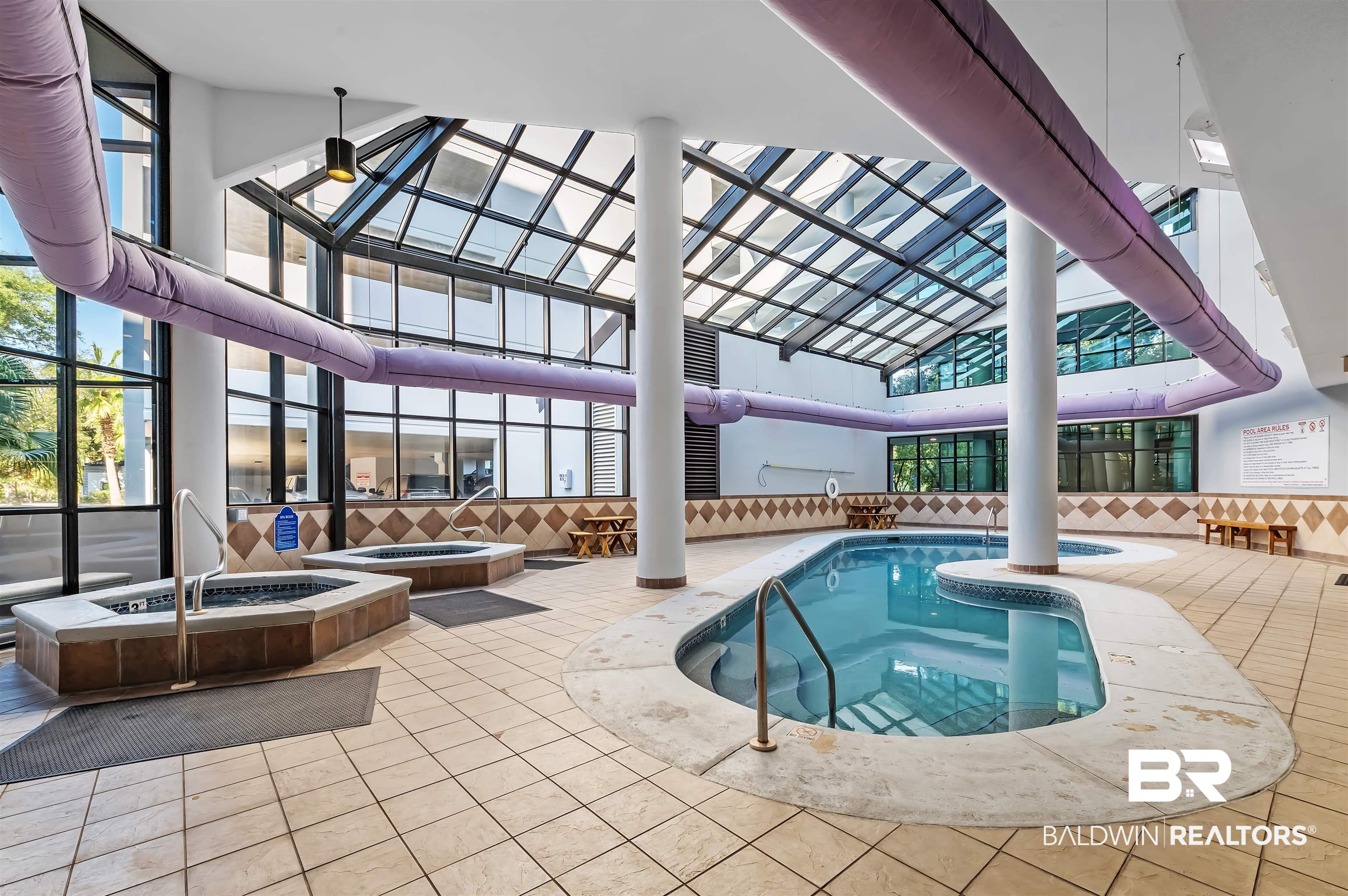 27582 Canal Road, Unit 2507 Orange Beach, AL 36561 - Photo 64 of 75 Indoor community pool featuring a hot tub, a patio, glass enclosure, and an outdoor fire pit