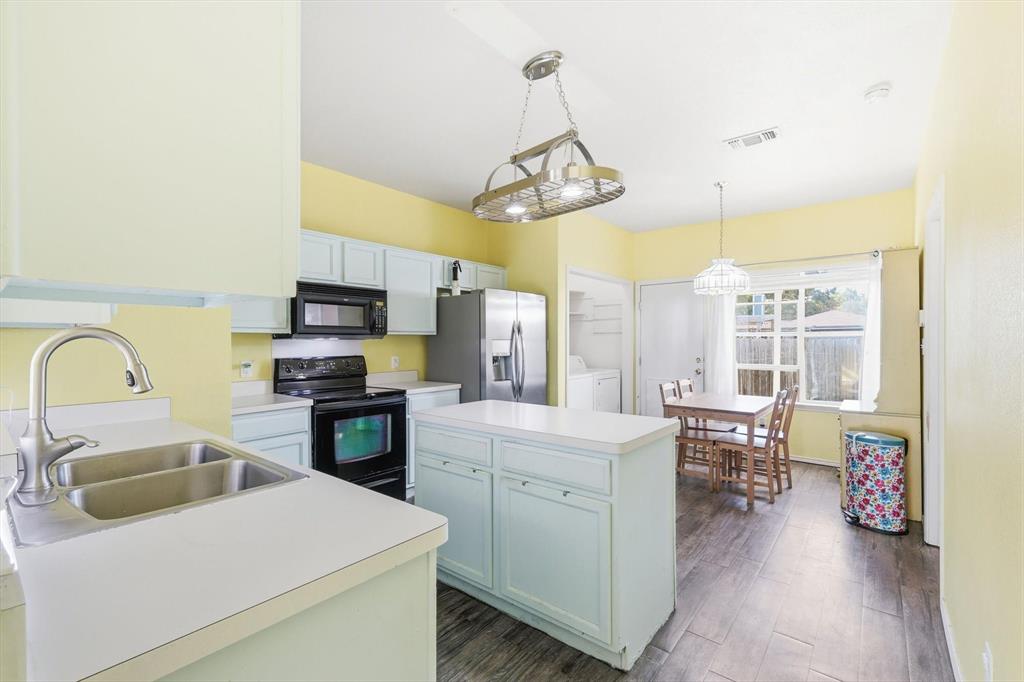 801 Indigo Terrace Denton, TX 76209 - Photo 12 of 40 a kitchen that has a lot of cabinets a sink and appliances