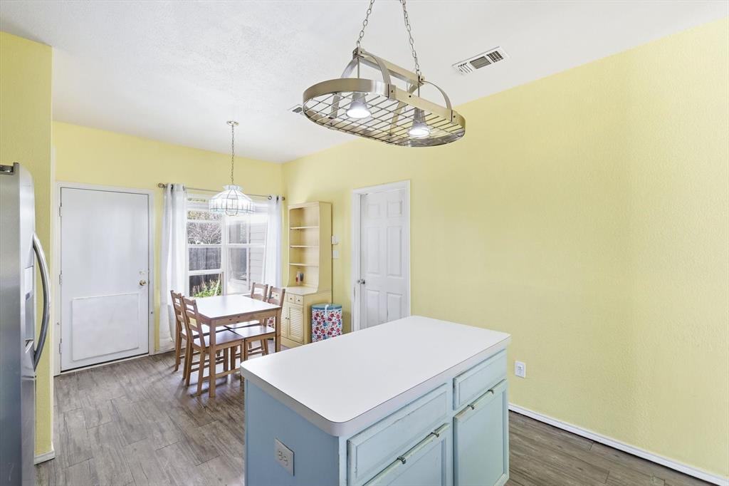 801 Indigo Terrace Denton, TX 76209 - Photo 17 of 40 a view of a dining room with furniture window and wooden floor