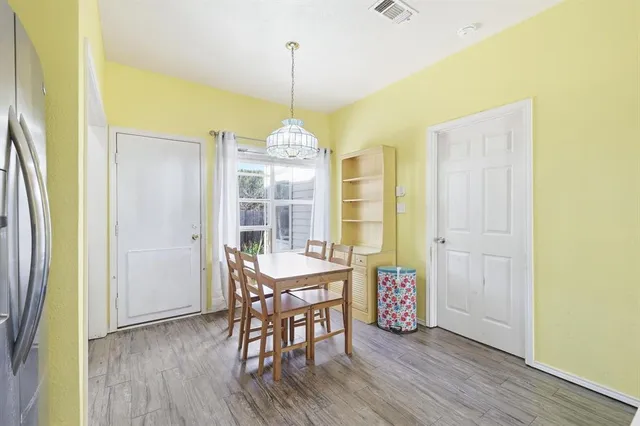 a view of a dining room with furniture and chandelier