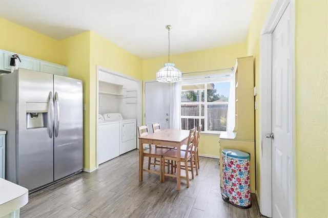 a dining room with furniture a chandelier and wooden floor