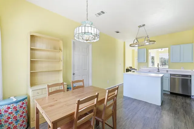 a view of a dining room with furniture wooden floor and chandelier