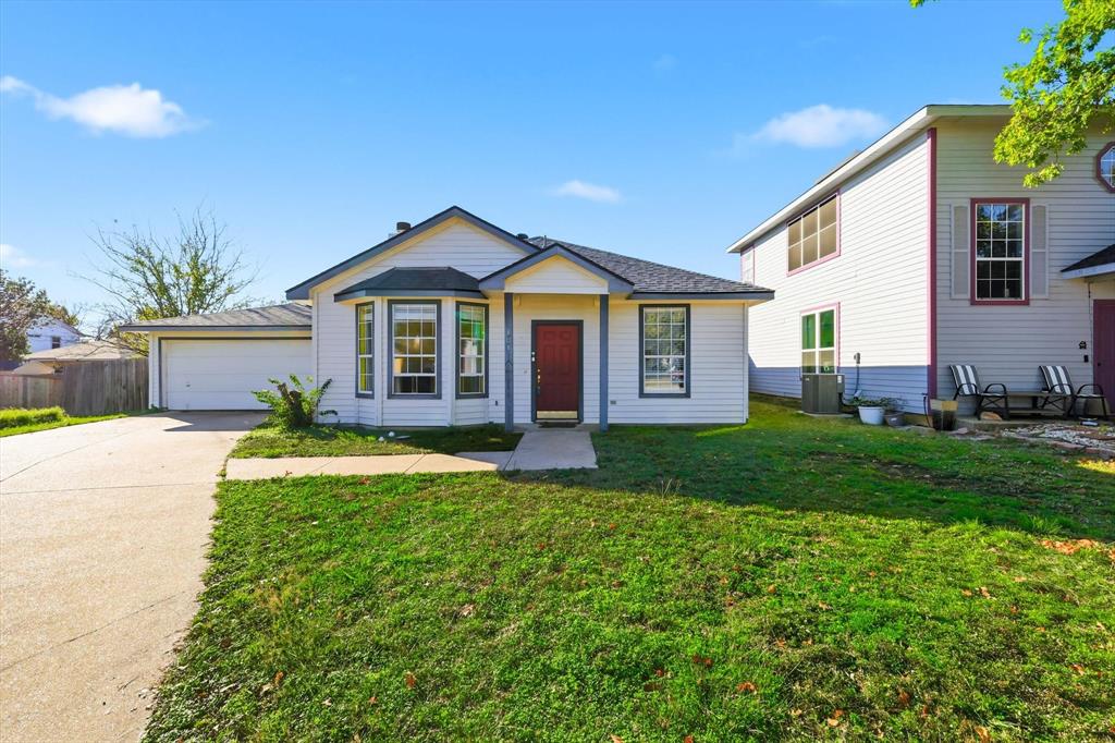 801 Indigo Terrace Denton, TX 76209 - Photo 2 of 40 a view of a yard in front of a house with a large tree