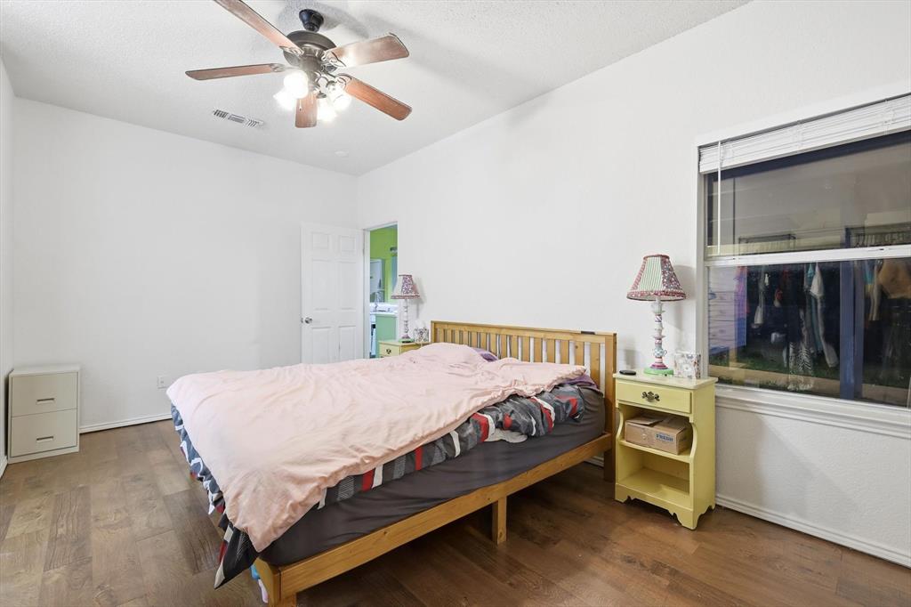 801 Indigo Terrace Denton, TX 76209 - Photo 24 of 40 a bedroom with a bed and a chandelier