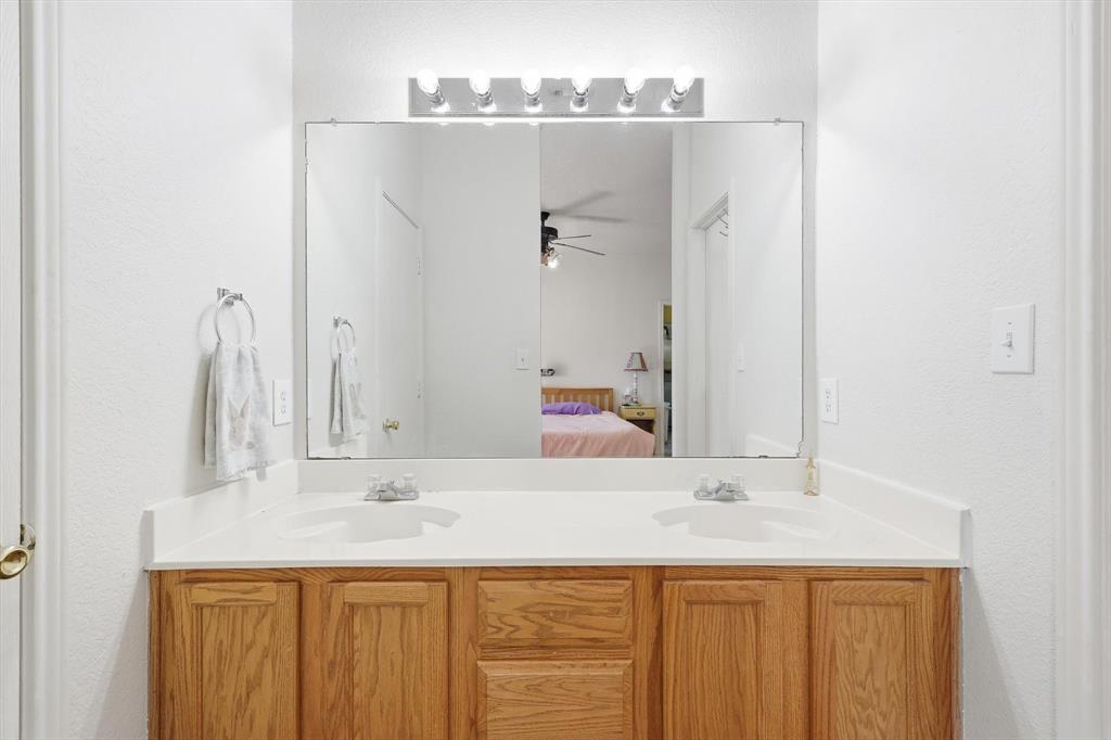 801 Indigo Terrace Denton, TX 76209 - Photo 26 of 40 a bathroom with a sink and a mirror