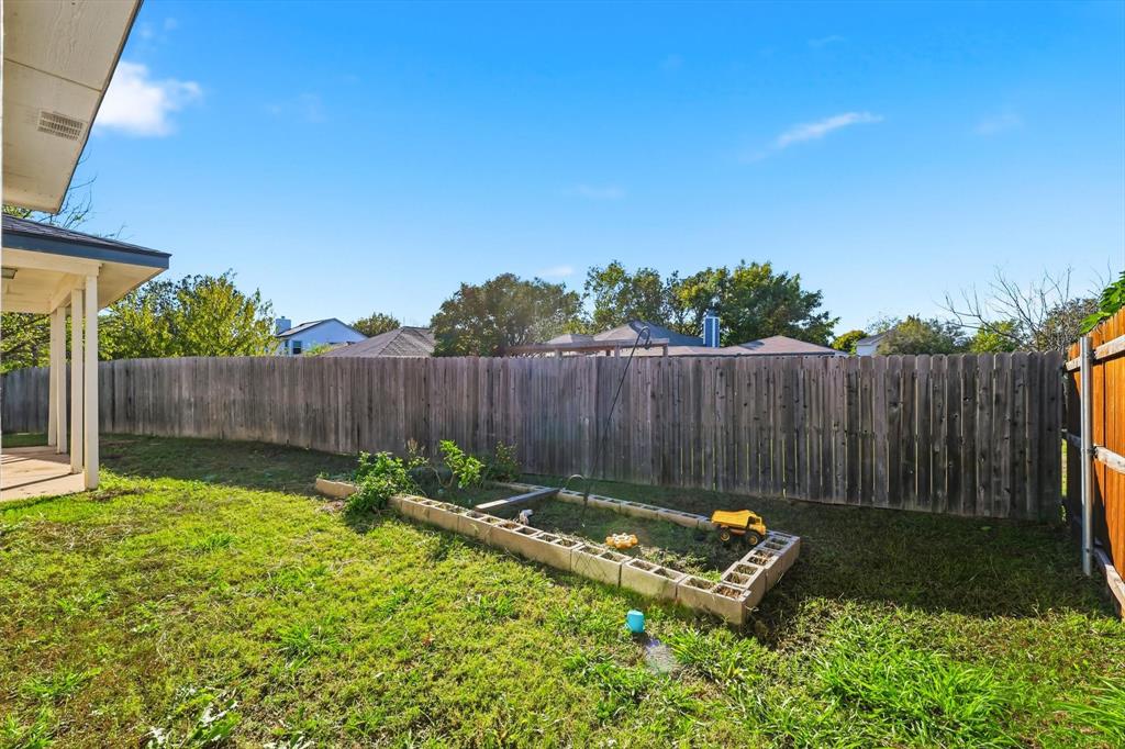 801 Indigo Terrace Denton, TX 76209 - Photo 40 of 40 a backyard of a house with table and chairs