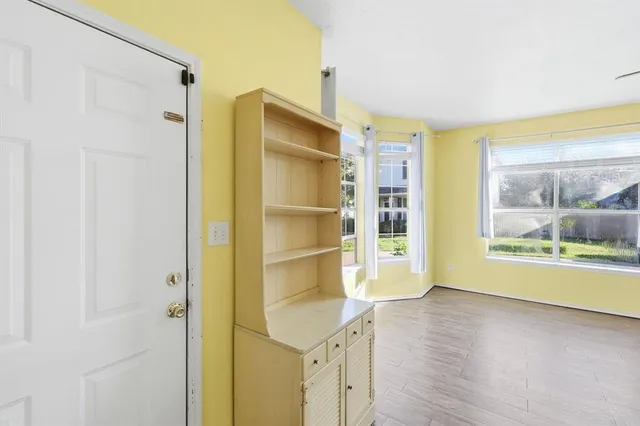 a room with a wooden floor and a window