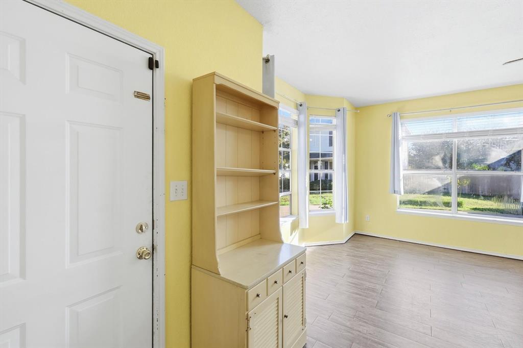 801 Indigo Terrace Denton, TX 76209 - Photo 4 of 40 a room with a wooden floor and a window