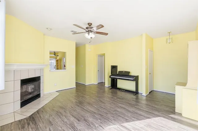 a view of an empty room with a fireplace and a window