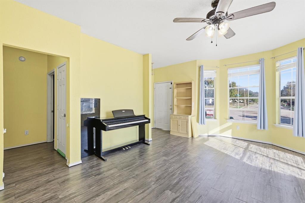 801 Indigo Terrace Denton, TX 76209 - Photo 7 of 40 a living room with a hard wood floor