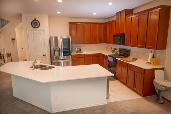 a kitchen with stainless steel appliances sink stove refrigerator and microwave