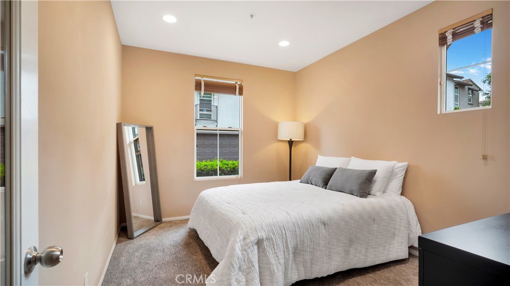 47 Nightshade Irvine, CA 92603 - Photo 15 of 56 a bedroom with a bed and a refrigerator