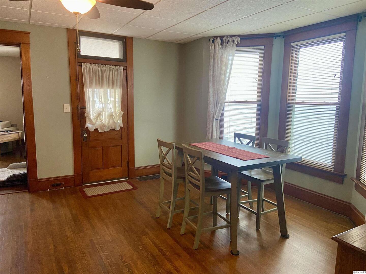 614 South 22nd Street Quincy, IL 62301 - Photo 3 of 27 a view of a dining room with furniture window and wooden floor