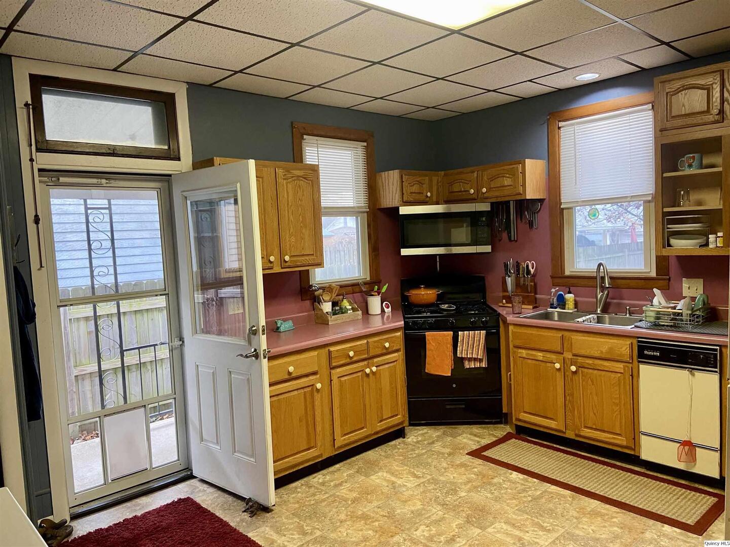 614 South 22nd Street Quincy, IL 62301 - Photo 8 of 27 a kitchen with stainless steel appliances granite countertop a stove a sink and a microwave