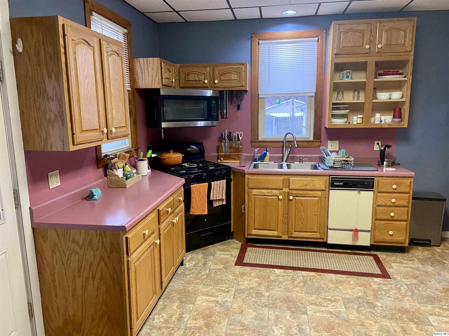 614 South 22nd Street Quincy, IL 62301 - Photo 9 of 27 a kitchen with a stove window and cabinets