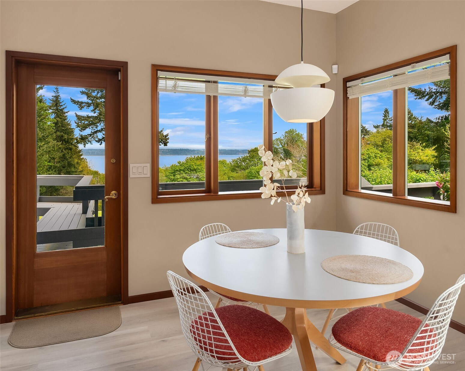 8425 Southwest 216th Street Vashon, WA 98070 - Photo 17 of 40 a dining room with furniture a chandelier and wooden floor