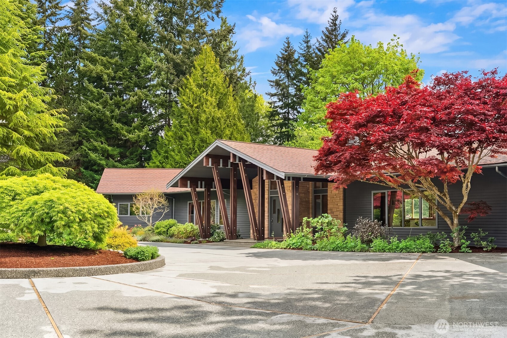 8425 Southwest 216th Street Vashon, WA 98070 - Photo 4 of 40 a front view of a house with a garden