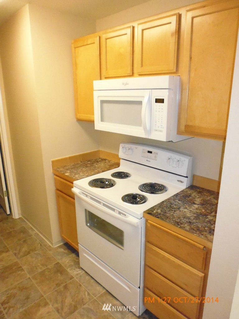335 Heather Road, Unit 307 Everett, WA 98203 - Photo 7 of 16 a stove top oven sitting inside of a kitchen