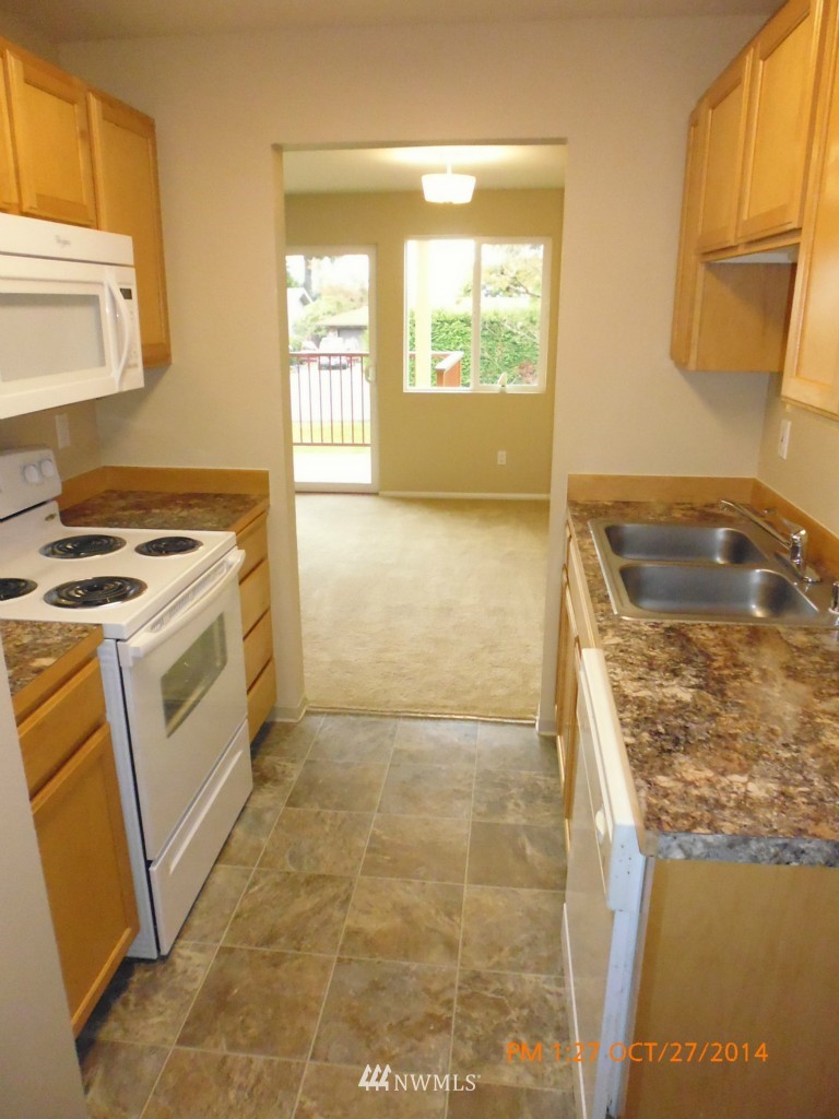 335 Heather Road, Unit 307 Everett, WA 98203 - Photo 9 of 16 a kitchen with a stove a sink and a refrigerator