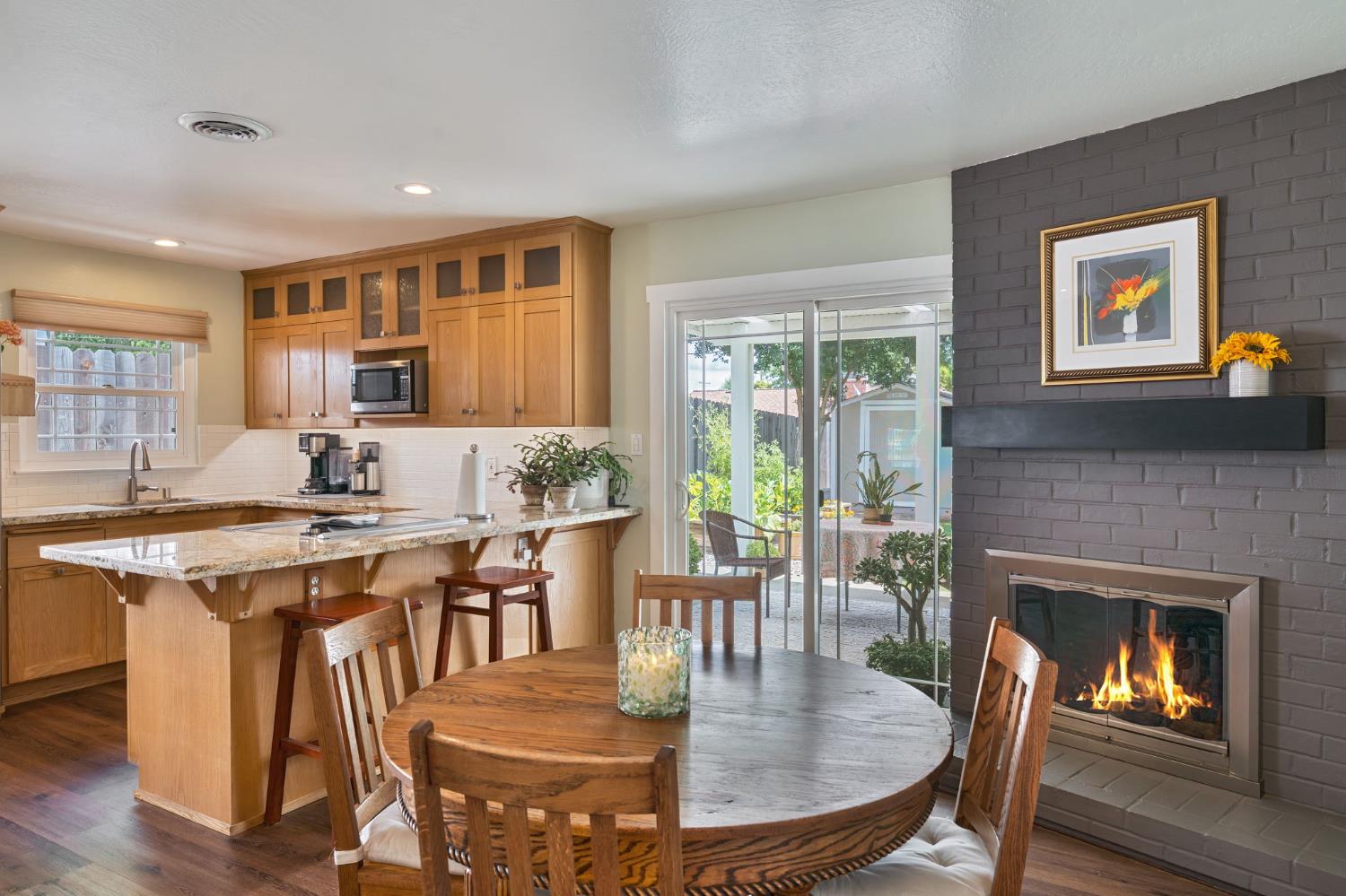 5422 Earnell Street Carmichael, CA 95608 - Photo 14 of 39 a kitchen with a table chairs and a fireplace