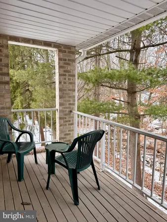 a view of a chairs and table in the balcony