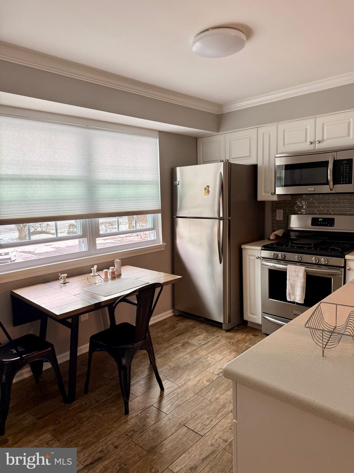 1202 Valley Glen Road Elkins Park, PA 19027 - Photo 3 of 13 a kitchen with refrigerator cabinets and wooden floor