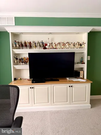 a living room with a bookshelf and a chair