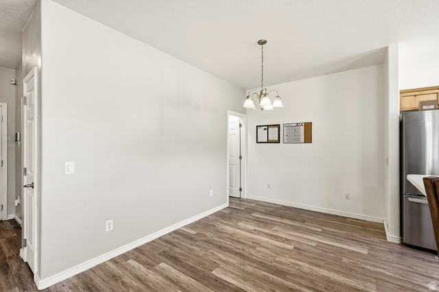 1177 Northfield Road, Unit 26 Cedar City, UT 84721 - Photo 9 of 45 Open dining area featuring wood-finish flooring and a contemporary chandelier