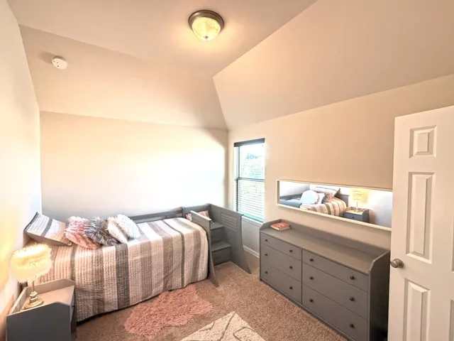 a bedroom with a bed and a dresser