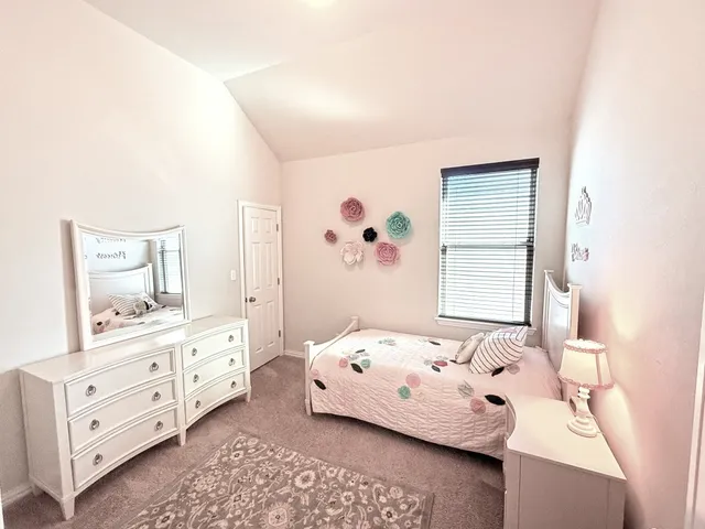 a bedroom with a bed and window