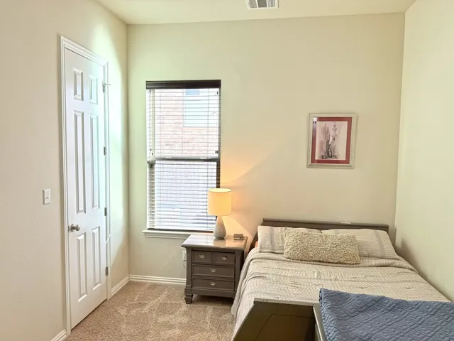a bedroom with a bed and a window