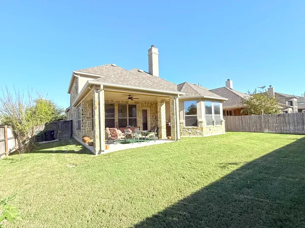 a front view of a house with a garden and yard