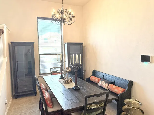 a view of a dining room with furniture and window