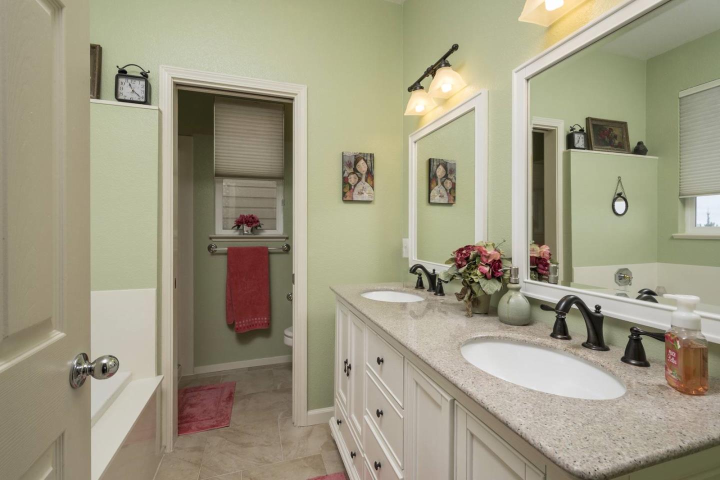554 Monterey Road Pacifica, CA 94044 - Photo 22 of 32 a bathroom with a granite countertop double vanity sink and a mirror