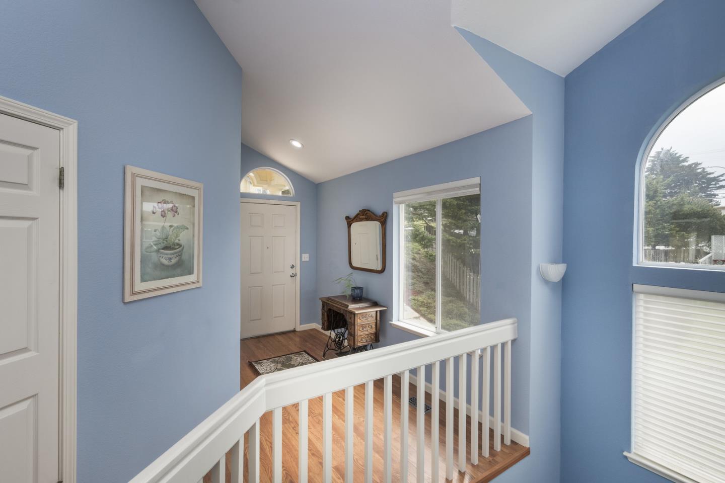 554 Monterey Road Pacifica, CA 94044 - Photo 7 of 32 a view of a hallway with wooden floor and windows