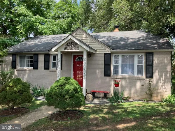 a house with lots of trees in the background