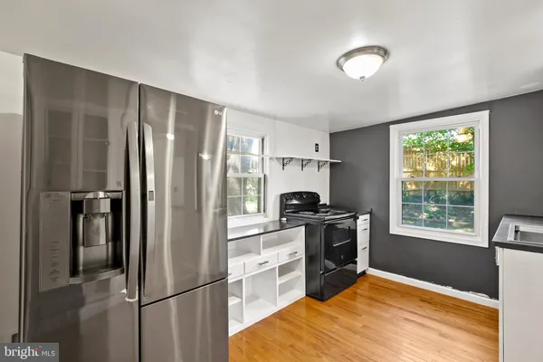 a kitchen with a refrigerator a stove top oven and a refrigerator