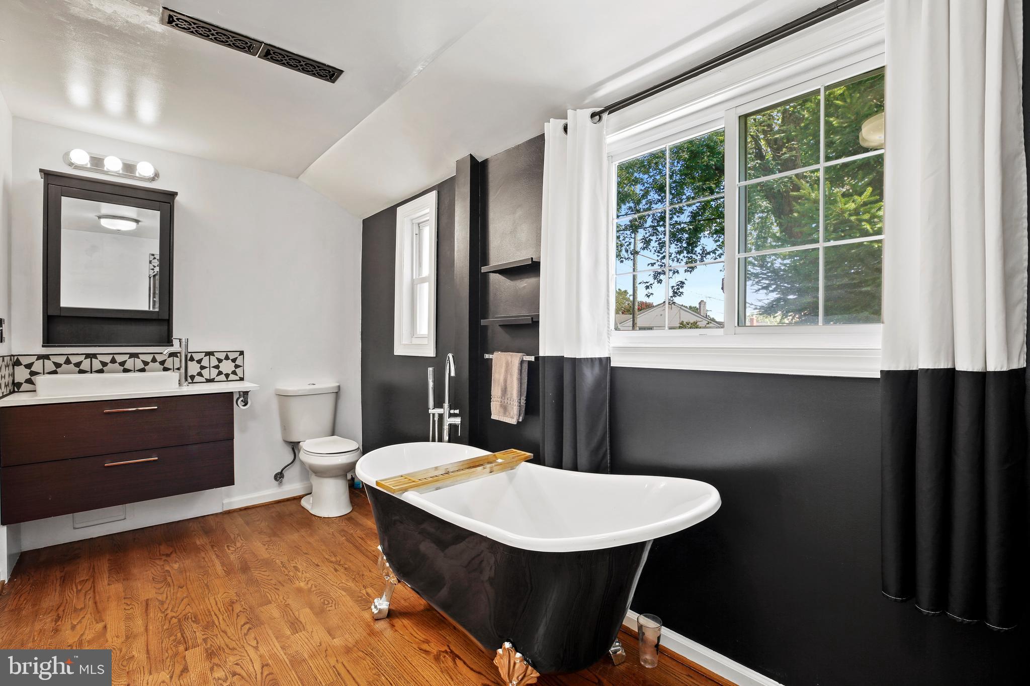 3303 Janet Road Silver Spring, MD 20906 - Photo 16 of 31 a living room with a couch and a dresser next to a window
