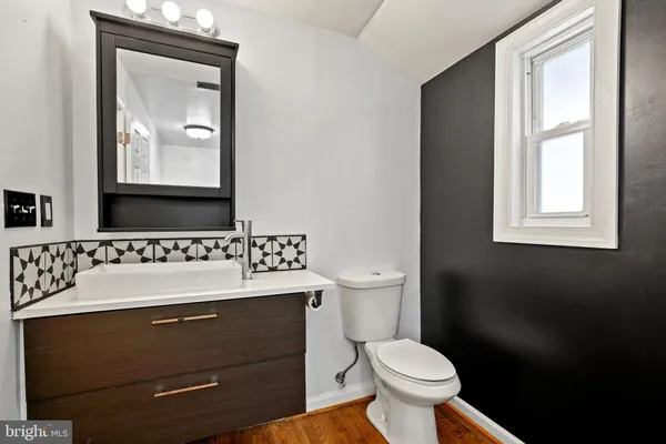 a bathroom with a toilet sink and mirror