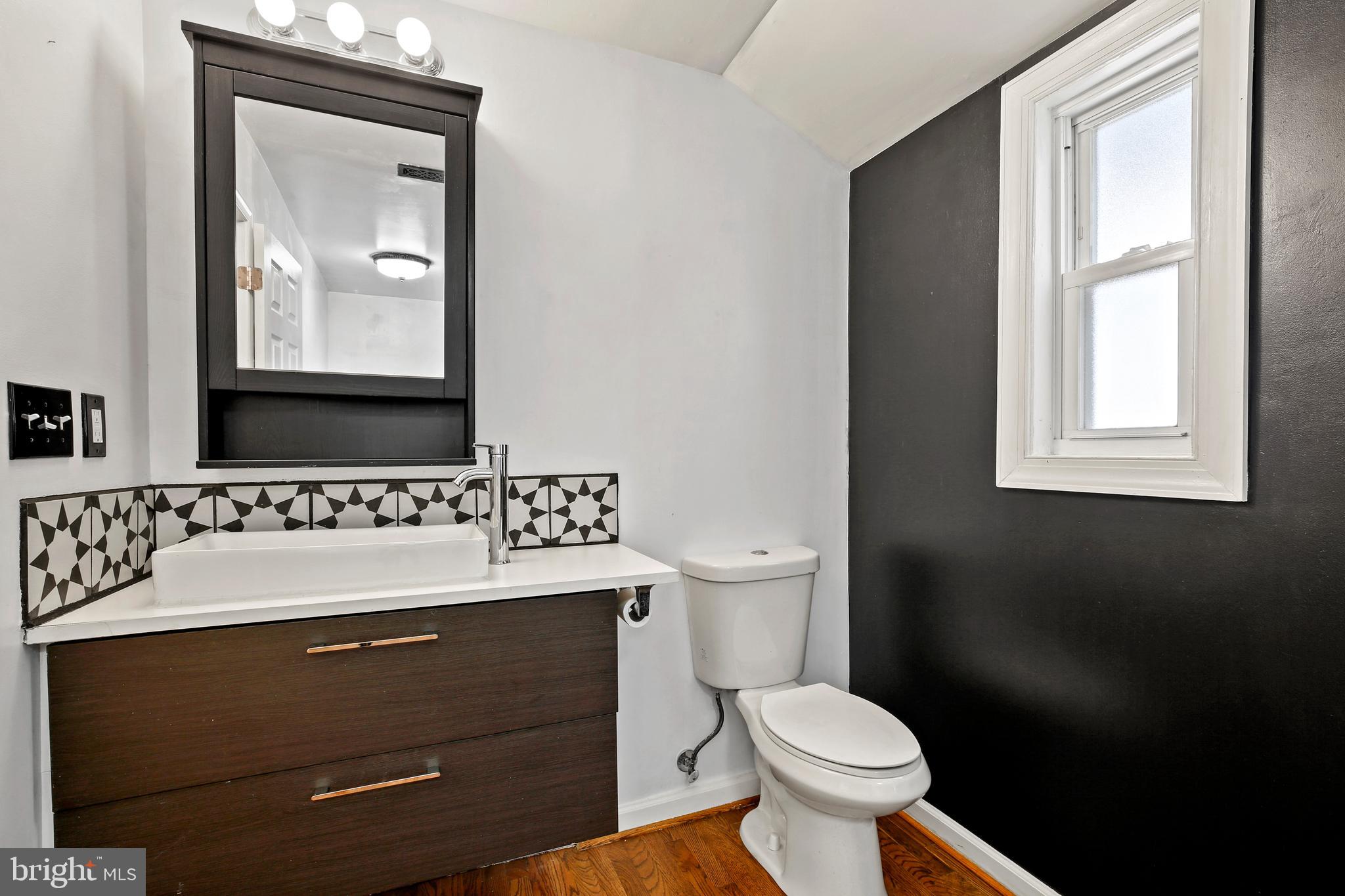 3303 Janet Road Silver Spring, MD 20906 - Photo 17 of 31 a bathroom with a toilet sink and mirror