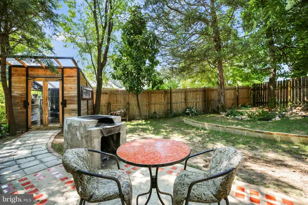 a backyard of a house with yard barbeque oven and outdoor seating