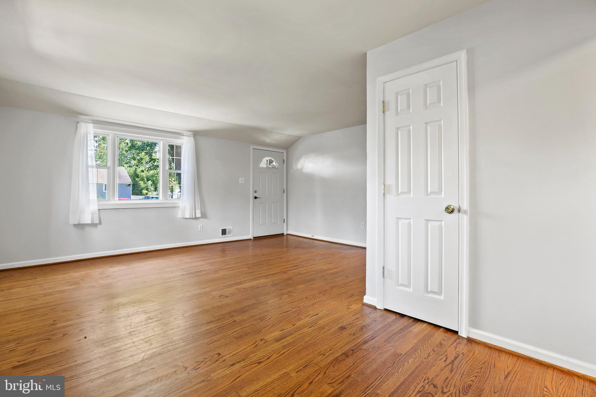 3303 Janet Road Silver Spring, MD 20906 - Photo 8 of 31 a view of an empty room with wooden floor and a window