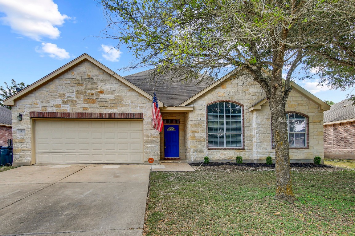 a front view of a house with garden