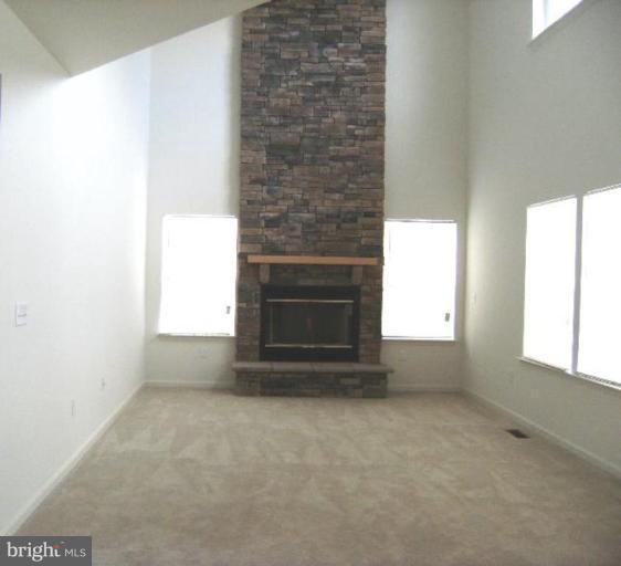64 Mineral Springs Road Ranson, WV 25438 - Photo 5 of 12 a view of empty room with a fireplace