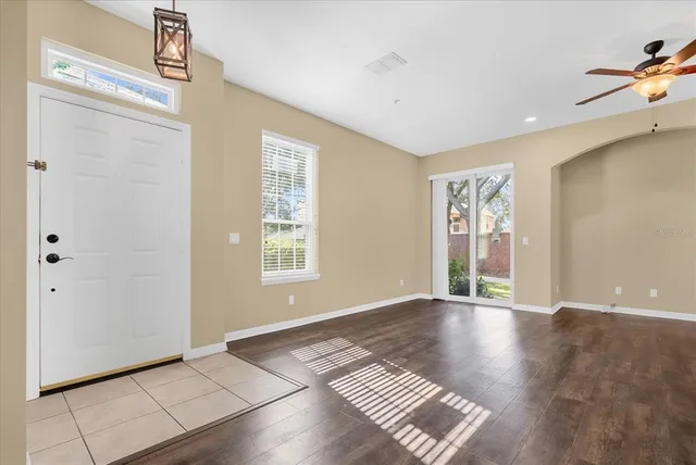 a view of an empty room with glass door and window