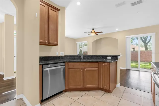 a kitchen with stainless steel appliances granite countertop a sink and a microwave