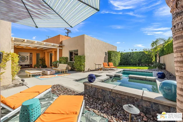 a view of a backyard with plants and lake view