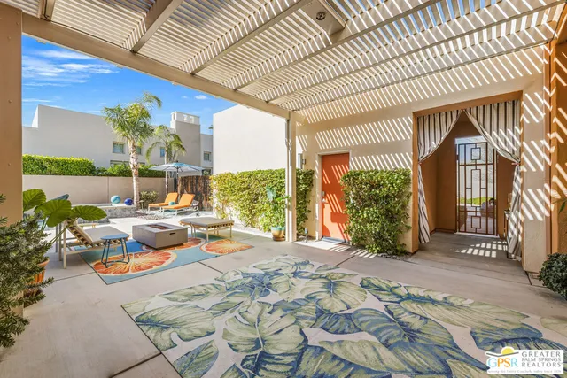 a view of swimming pool with outdoor seating and plants