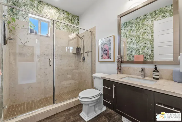 a bedroom with a bed and a flat tv screen